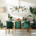 Load image into Gallery viewer, glass globe chandelier in dining room above a white table with green chairs
