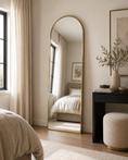 Load image into Gallery viewer, gold arched mirror in bedroom across from bed and next to console table
