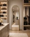 Load image into Gallery viewer, gold arched mirror in a luxury closet across from closet island
