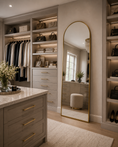 Load image into Gallery viewer, gold arched mirror in master closet next to shelves with purses and across from island
