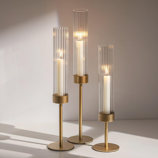 gold candle holder 3 pc on table in a white space
