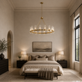 Load image into Gallery viewer, A modern gold chandelier with clear crystal candle-style bulbs hangs over a neatly made bed in a beautifully styled, warm-toned bedroom with beige walls, matching nightstands, and a tufted bench.
