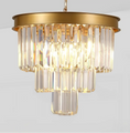 Load image into Gallery viewer, Three-tier gold chandelier with elongated multi-angled crystal bars and matte black metal frame on white background
