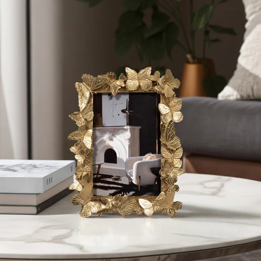 gold picture frame on table in living room