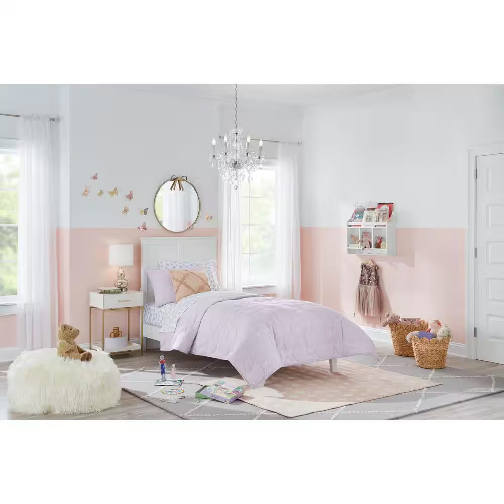 gold round mirror in girls bedroom above bed