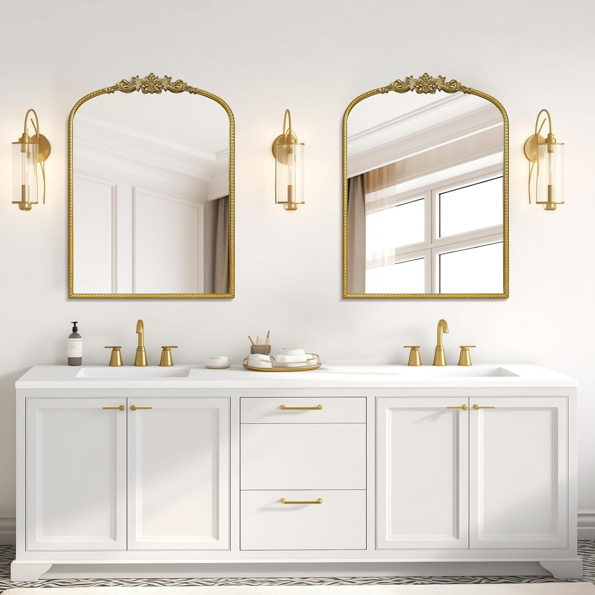 gold wall mirror above each sink in bathroom
