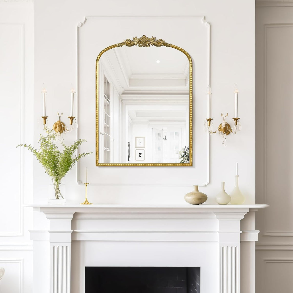 gold wall mirror above fireplace in living room