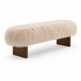 Load image into Gallery viewer, The harlow bench with a fluffy cream-colored faux fur or sheepskin seat and dark brown wooden legs, shown against a plain white background.
