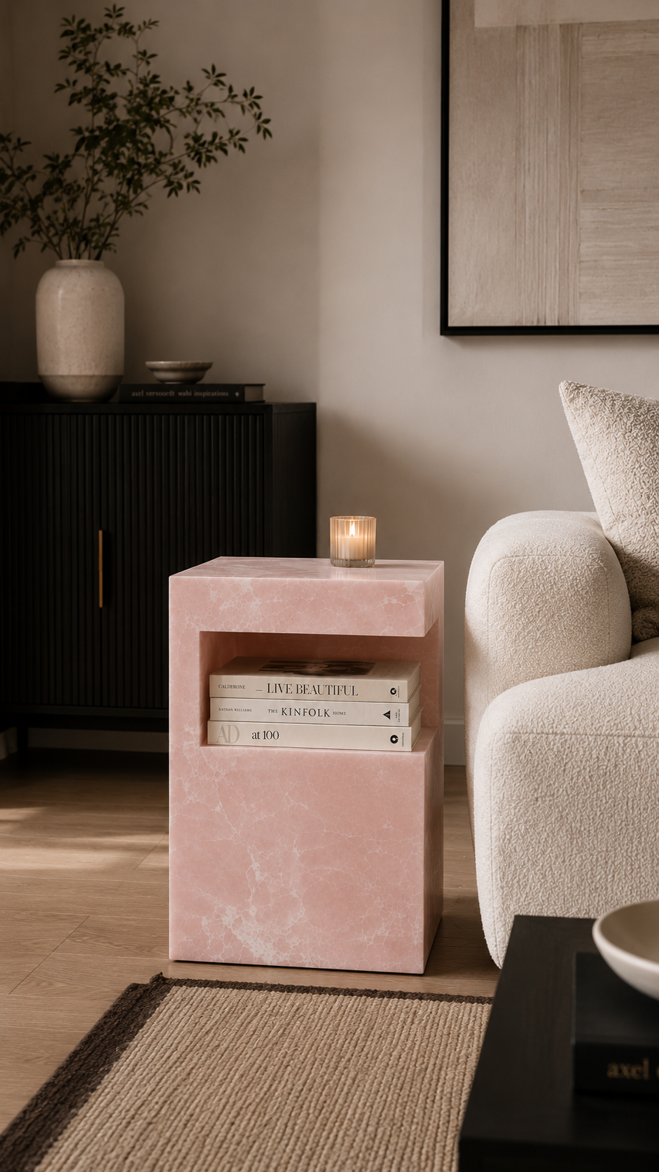 HARPER ONYX STONE TABLE in living room with a candle on it next to an area rug and sofa