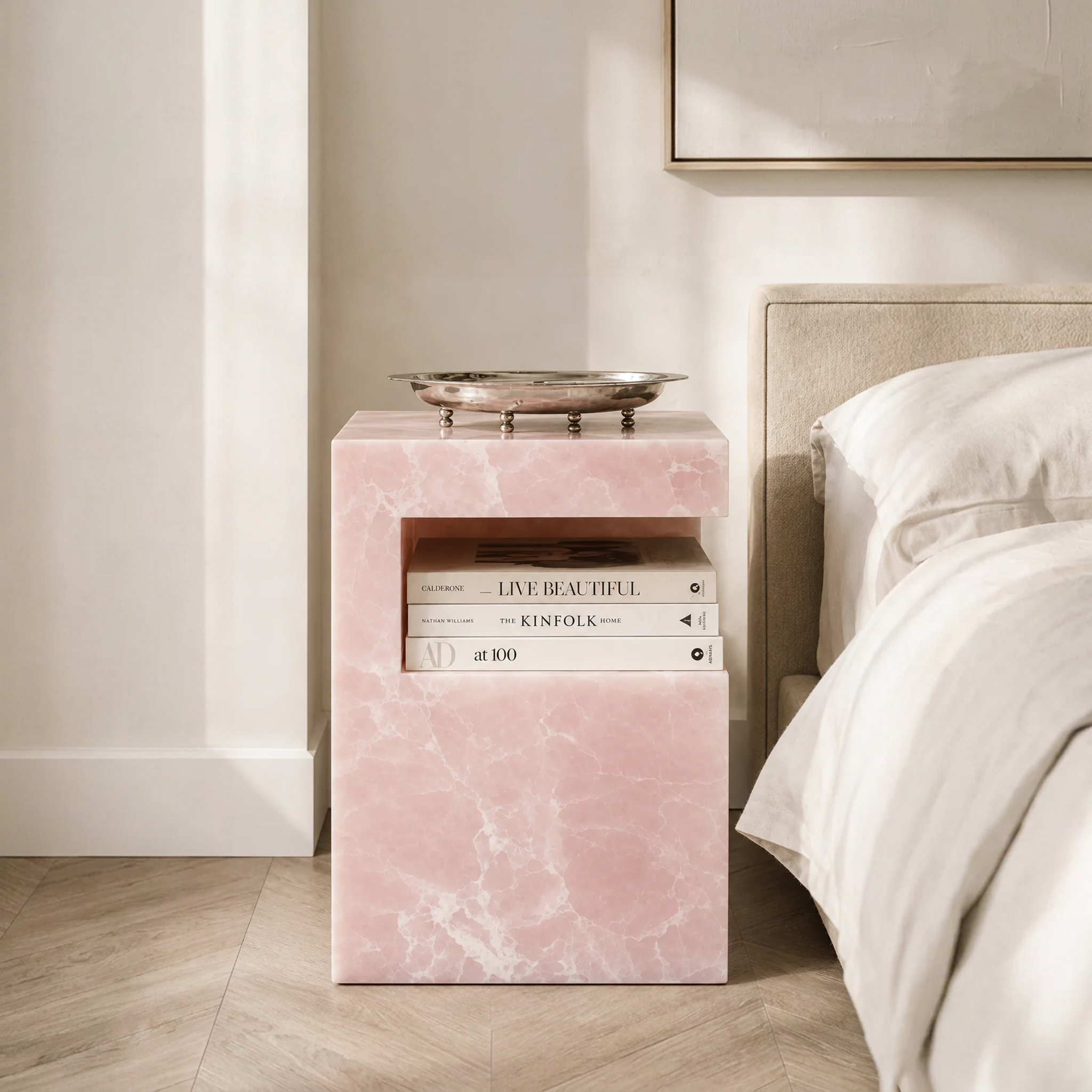 HARPER ONYX STONE TABLE with books in it and a tray on top in a bedroom