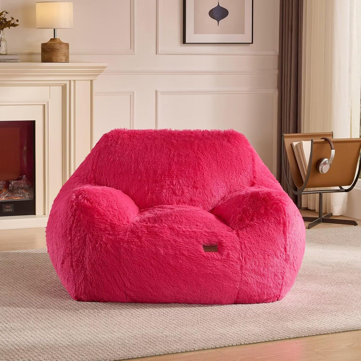 PINK PUFF FLOOR CHAIR in room with fireplace and a small lamp