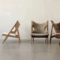 Load image into Gallery viewer, Three House of Effy minimalist chairs with sleek design, one tipped over, standing on a concrete floor against a plain wall.
