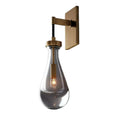 Load image into Gallery viewer, The RAIN SCONCE by House of Effy offers a sleek design with a brass backplate and arm, complemented by a teardrop-shaped glass shade that exposes an internal lightbulb, creating a luxury ambiance.
