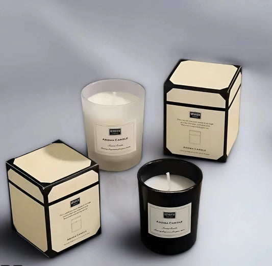 Two House of Effy luxury jasmine candles with one lit, displayed beside their packaging on a gradient gray background.