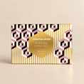 Load image into Gallery viewer, Jonathan Adler Playing Card Set box featuring a gold, white, and pink geometric pattern on a light beige background.
