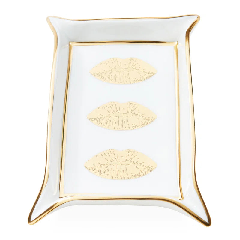 White decorative tray with gold accents and embossed designs on a white background