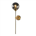 Load image into Gallery viewer, A contemporary wall sconce with a brass finish featuring a spherical black glass shade and a slim, elongated design, this elegant CONTEMPORARY WALL SCONCE by House of Effy adds a touch of luxurious lighting to any space.
