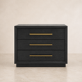 Load image into Gallery viewer, A three-drawer nightstand or side table in a dark black wood finish with slim horizontal gold metal handles, set against a neutral beige background.
