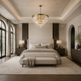 Load image into Gallery viewer, A luxury bedroom featuring a large round gold crystal chandelier hanging over a bed with neutral beige bedding, flanked by matching nightstands and lamps in a high-ceilinged, elegant room.
