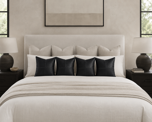leather pillow cover in room on bed and the bed is inbetween two nightstands