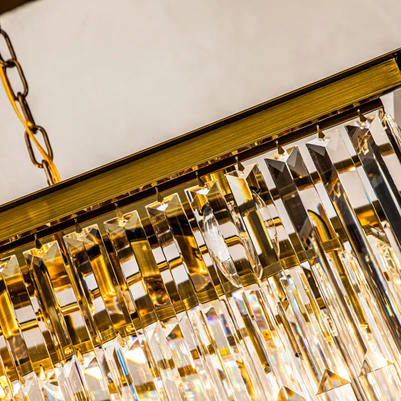 linear crystal chandelier close-up of a gold chandelier with crystal-like elements.