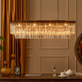Load image into Gallery viewer, linear crystal chandelier in room above a table
