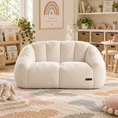 Load image into Gallery viewer, love seat sofa is placed in a cozy, styled children's room with a patterned rug, shelves, and toys.
