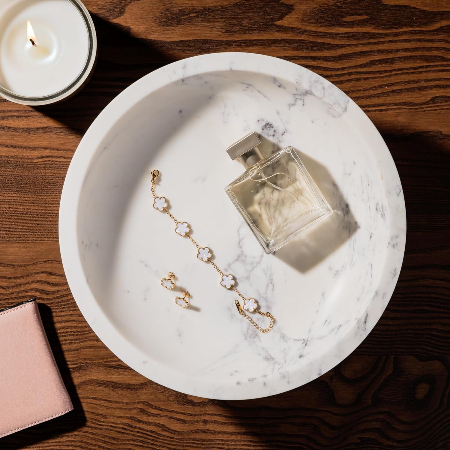 marble bowl with jewelry and cologne bottle in it