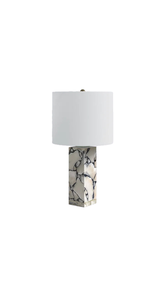 Marble table lamp with marble base and white shade on a white background