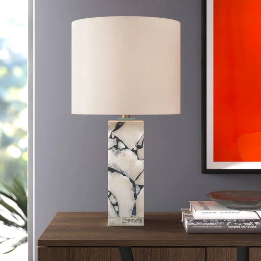 Marble Table Lamp on table in living room beside art work and books