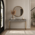 Load image into Gallery viewer, A modern console table with gold legs and a round gold-framed mirror mounted above it in a bright entryway. The table is styled with a beige vase of pampas grass, a book, and a white candle, set against a light beige paneled wall.
