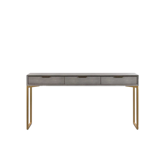 A modern console table featuring a gray textured wood top, three drawers with dark metal handles, and slim gold-finished metal legs, shown against a plain white background.