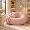 Load image into Gallery viewer, pink pumpkin chair in a reading nook next to an accent table with a blanket draped on it
