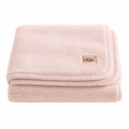 Load image into Gallery viewer, A folded light pink UGG pink throw blanket with a small tan UGG logo patch on the corner, set against a plain white background.
