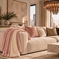 Load image into Gallery viewer, Pink UGG throw blanket draped over a cream sofa in a modern living room
