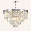 Load image into Gallery viewer, A modern multi-tier round crystal chandelier with a polished silver-tone metal frame and hanging chain, shown against a solid off-white background.
