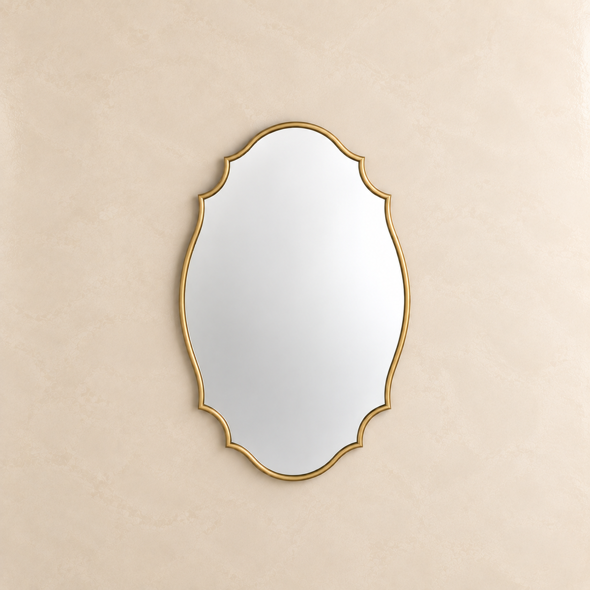 An ornate oval wall mirror with a gold scalloped frame, mounted on a textured beige wall.