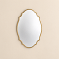 Load image into Gallery viewer, An ornate oval scalloped wall mirror with a gold scalloped frame, shown against a solid beige background.
