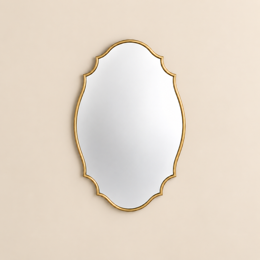 An ornate oval scalloped wall mirror with a gold scalloped frame, shown against a solid beige background.