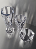 Load image into Gallery viewer, Set of clear faceted crystal decorative bowls and vases with geometric shapes on a reflective surface
