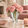 Load image into Gallery viewer, Shannon Crystal Vase by Orrefors with pink hydrangeas on a marble coffee table in an elegant living room with blush pink accents.
