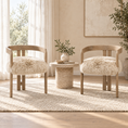 Load image into Gallery viewer, Two wooden armchairs with fluffy cream faux-fur seats are placed on a light rug in a bright, neutral-toned room with a small round side table between them.

