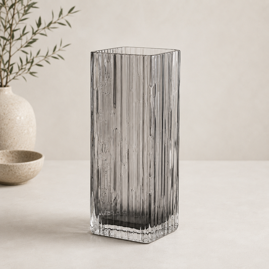 Smoked crystal vase with a tall rectangular shape and textured ribbed glass displayed against a neutral beige background.