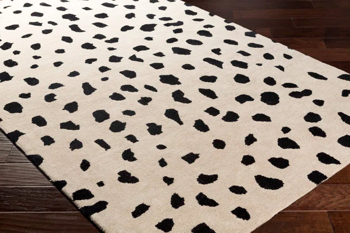 Poulos Area Rug angled view on top of hardwood flooring