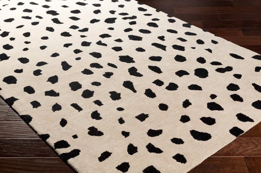 Poulos Area Rug angled view on top of hardwood flooring