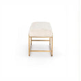 Load image into Gallery viewer, Ivory upholstered bench with brass-finished steel frame and bullnose edging on a white background

