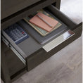Load image into Gallery viewer, writing desk drawer opened with items inside including a calculator, pen, and notebook
