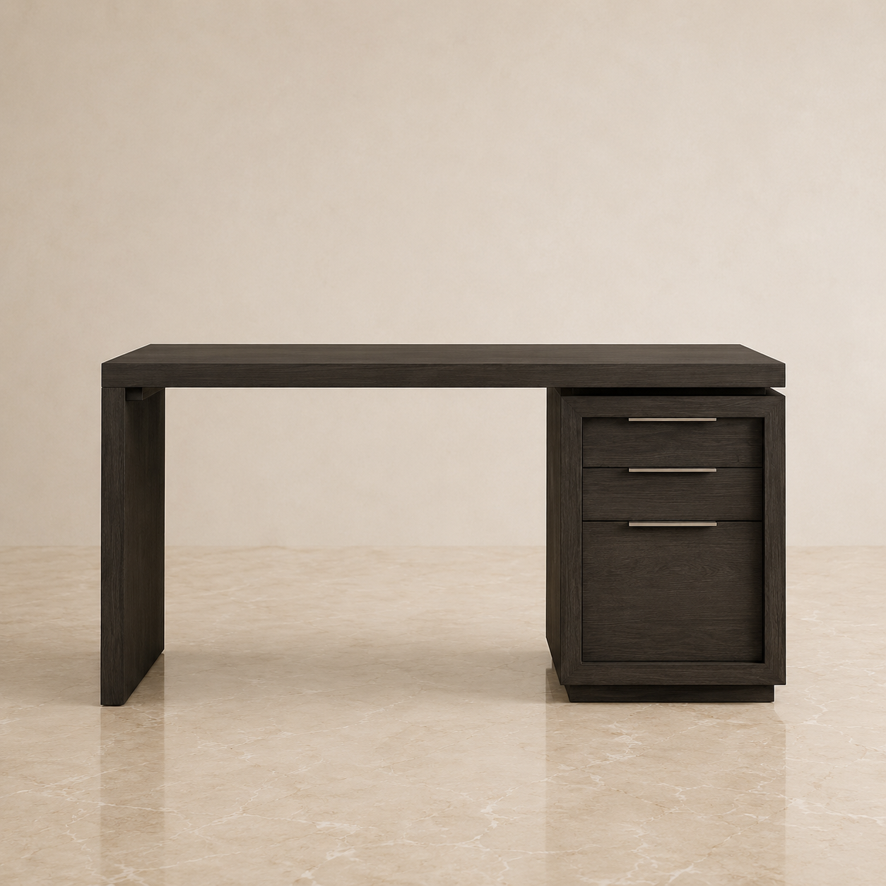 A modern dark wood writing desk with a three-drawer pedestal cabinet on the right side, featuring slim horizontal metal handles, set against a warm beige textured wall and marble floor.